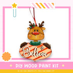 a DIY wood paint kit for creating ornaments, including a wooden reindeer ornament with the word "Believe" written on it.