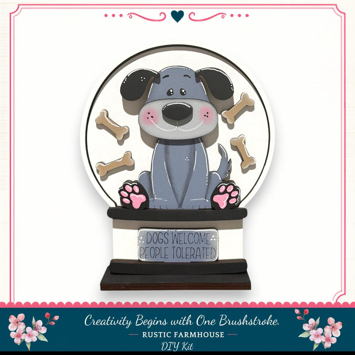 A wooden snow globe featuring a cartoon dog surrounded by dog bones, with a sign that says "Dogs Welcome People Tolerated".