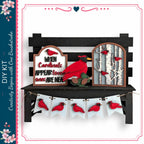 a decorative display with a black bench, a sign, and a banner. The sign has a red bird on it, and the banner has red birds on it. The bench is situated in front of the display, and the sign and banner are hanging from it.