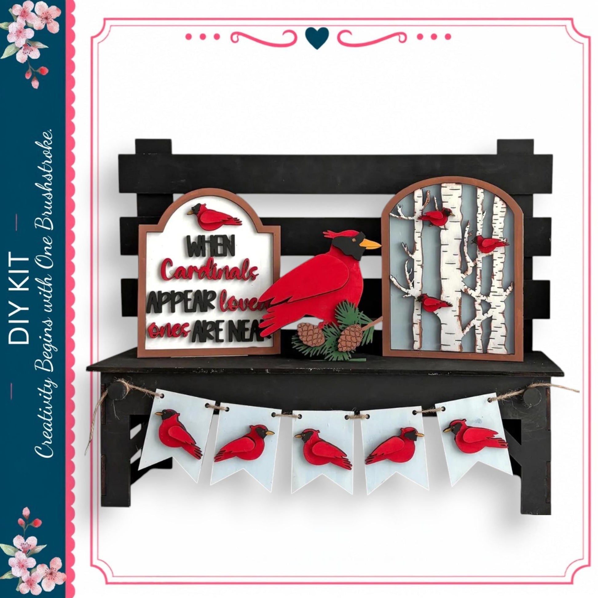 a decorative display with a black bench, a sign, and a banner. The sign has a red bird on it, and the banner has red birds on it. The bench is situated in front of the display, and the sign and banner are hanging from it.