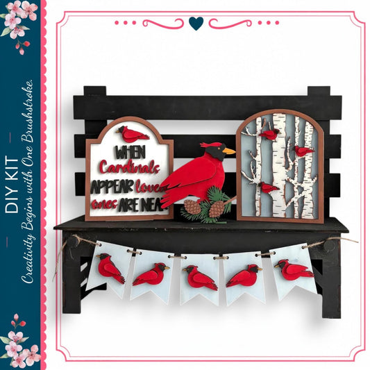 a decorative display with a black bench, a sign, and a banner. The sign has a red bird on it, and the banner has red birds on it. The bench is situated in front of the display, and the sign and banner are hanging from it.