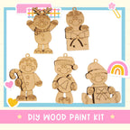 The image is a DIY wood paint kit featuring five wooden ornaments, including a gingerbread man, a snowman, a reindeer, a snowman, and a snowman.