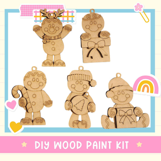 The image is a DIY wood paint kit featuring five wooden ornaments, including a gingerbread man, a snowman, a reindeer, a snowman, and a snowman.