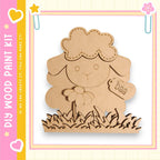 a wooden craft kit, specifically a sheep-shaped piece of wood, with a tag attached to it.