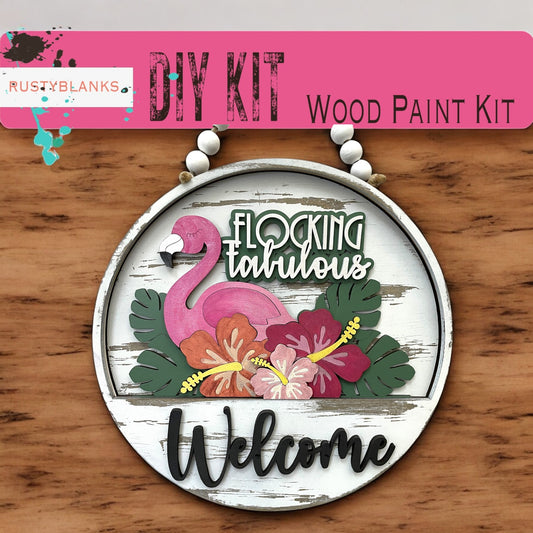 a wooden sign with a flamingo and flowers on it