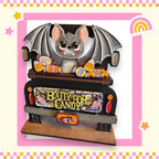A wooden toy truck decorated with a bat and various candy items, including a sign that says "Bally for Candy".