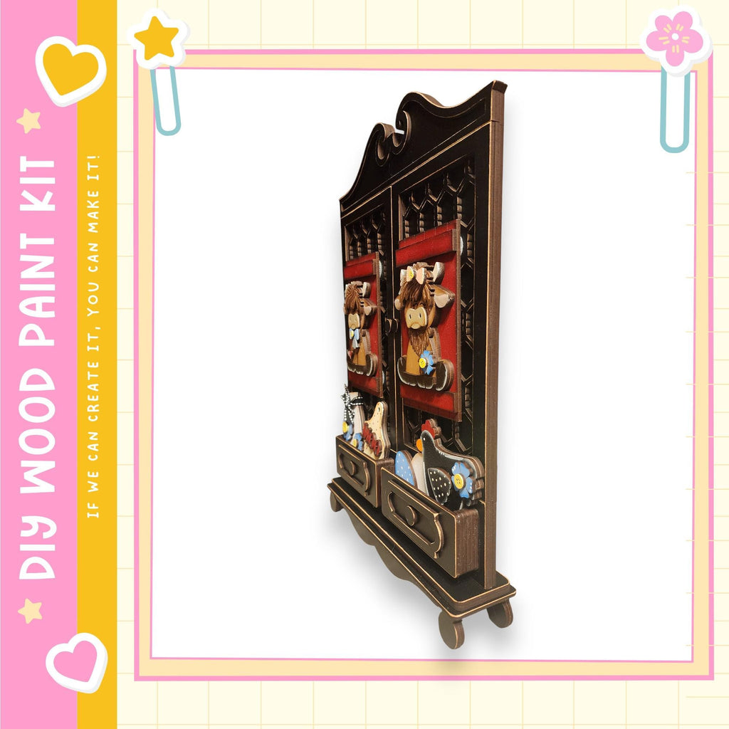 A wooden cabinet with decorative elements, such as a red curtain, a yellow star, and a pink flower, is shown in the image.