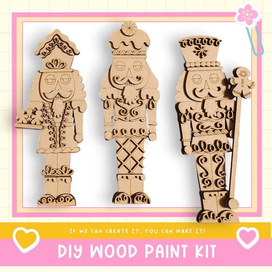 three wooden nutcracker figures, each with unique designs and accessories, displayed against a pink and yellow background.