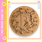 a round wooden wreath with a letter "P" carved into it.