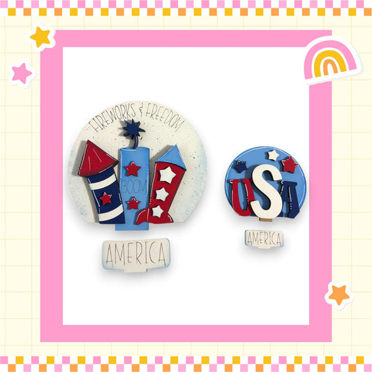 two circular decorations with the word "AMERICA" written on them, surrounded by various colorful and playful elements such as stars, a rainbow, and a firework.