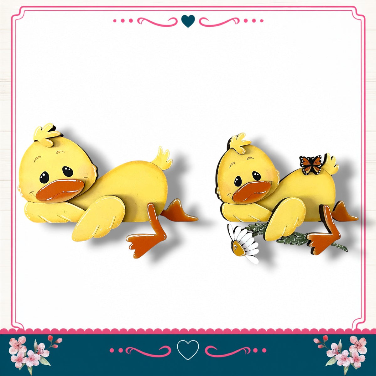 two yellow duck-shaped figures, one standing and one sitting, with flowers and a heart-shaped border surrounding them.