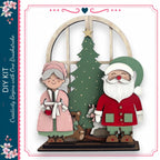 A DIY kit featuring a Christmas tree, Santa Claus, and a teddy bear, with a decorative border and floral elements.