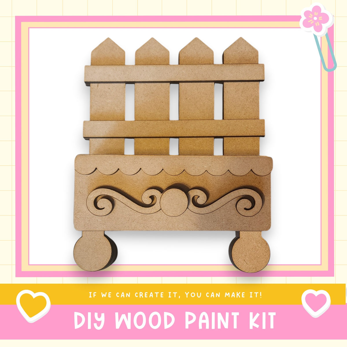 a DIY wood paint kit, with a wooden fence and decorative elements displayed.