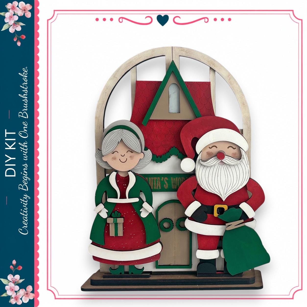 A wooden Christmas-themed display featuring a Santa Claus figure and an elderly woman, likely representing the "Santa's Workshop" as indicated by the text on the display.