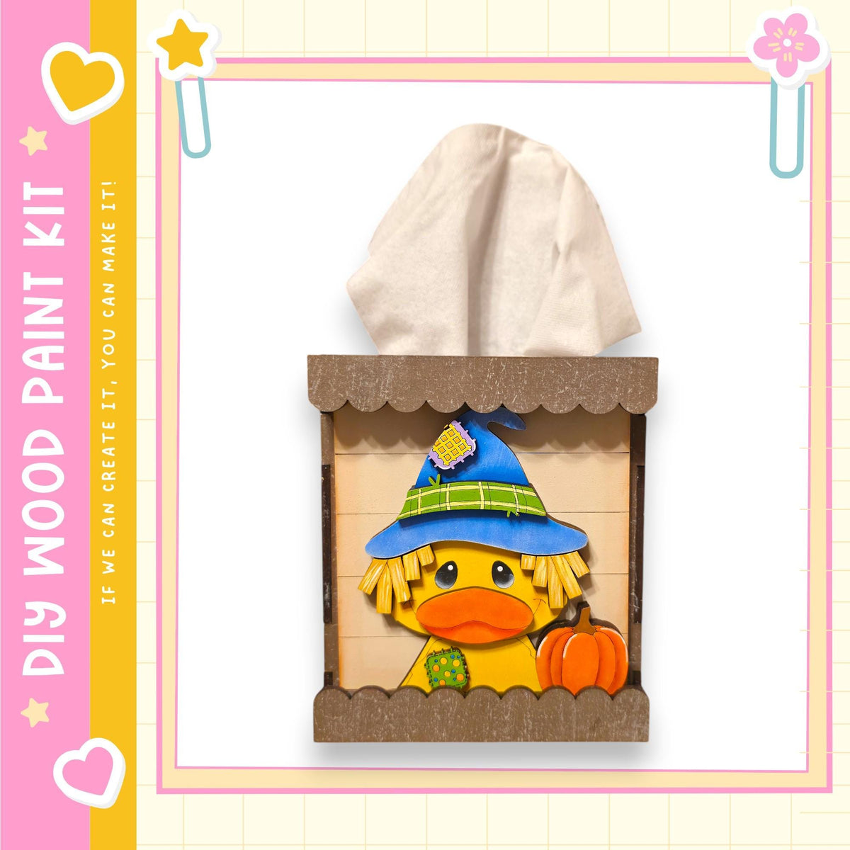 A wooden tissue box with a cartoon duck wearing a witch's hat and holding a pumpkin, set against a pink and yellow background with decorative elements.
