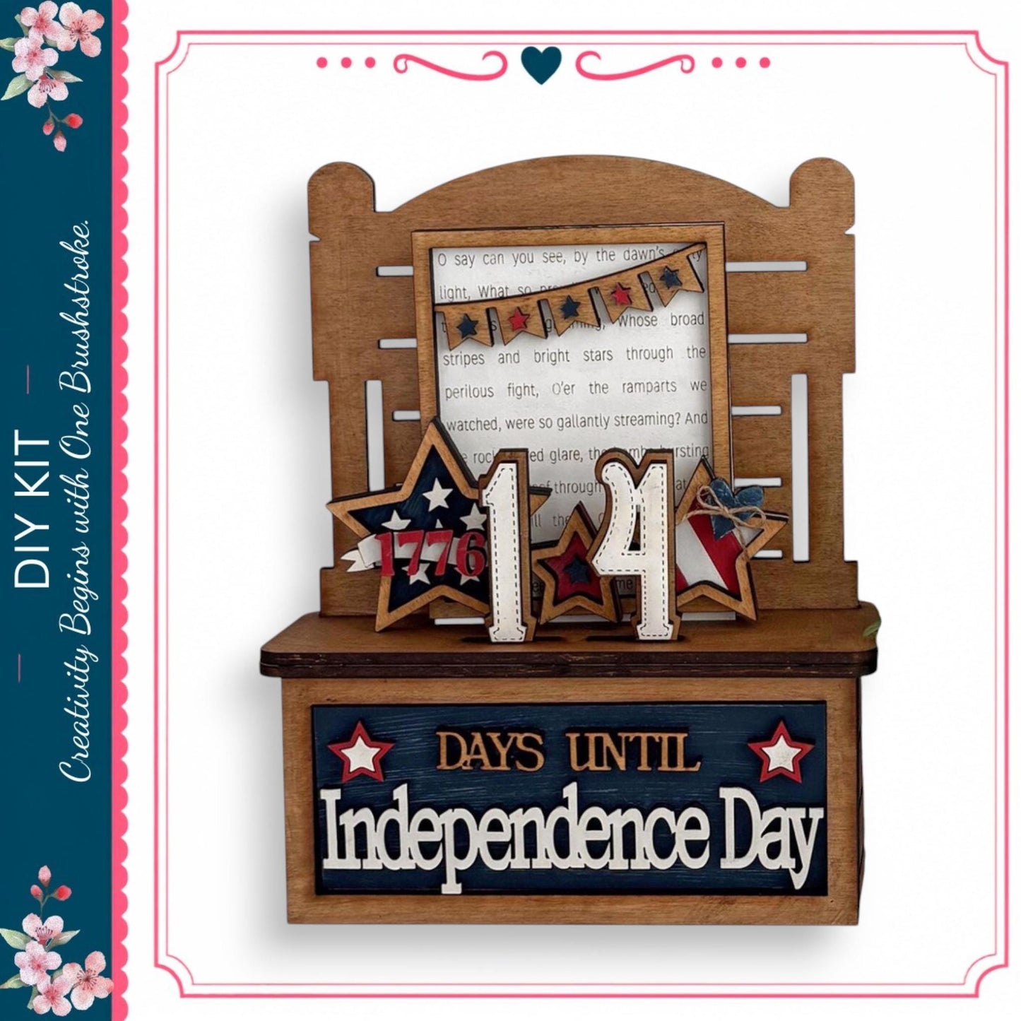 The image is a wooden display with a sign that reads "DAYS UNTIL Independence Day" and a banner with the number "14" and stars. The display is set against a white background, and there is a text box with a message that reads "I can see by the dawn, when the stars and stripes are through the perils, and the remnants were so clearly streaming."