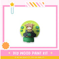 a paper craft kit with a picture of a girl sitting on a stool