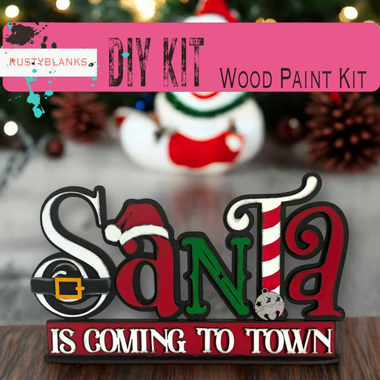 a wooden sign that says santa is coming to town