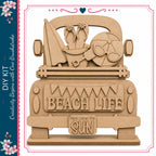 A wooden truck with various beach-themed items, including a surfboard, sunglasses, and a beach ball, along with the text "BEACH LIFE Here comes the SUN" carved into the back of the truck.