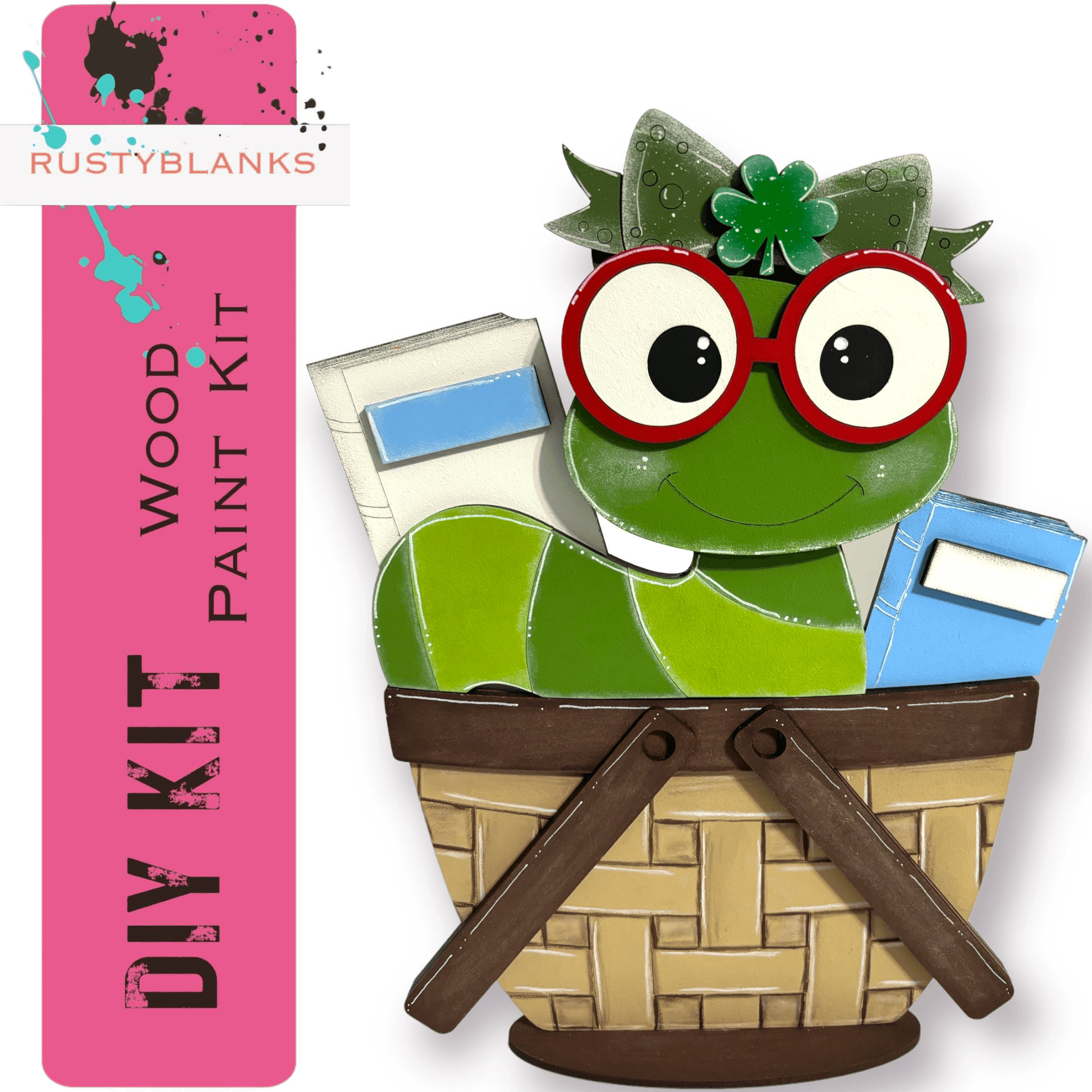 a green frog sitting in a basket holding a pair of scissors