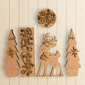 a collection of wooden cutouts, including a deer, trees, and a circular sign with the text "Merry & Bright".