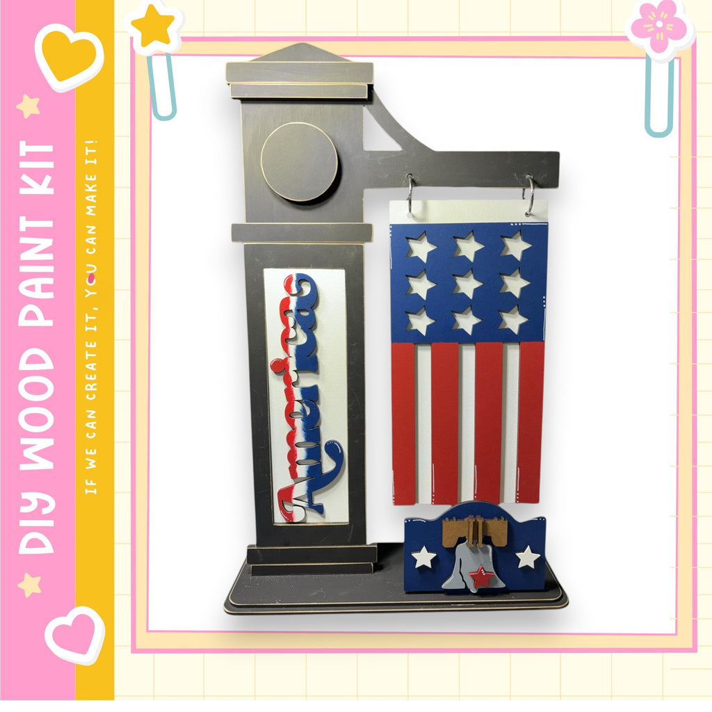 a DIY paint kit kit, which includes a wooden frame with an American flag design and a wooden plaque. The kit appears to be made of wood and is designed for creating a wooden frame with a painted American flag design.