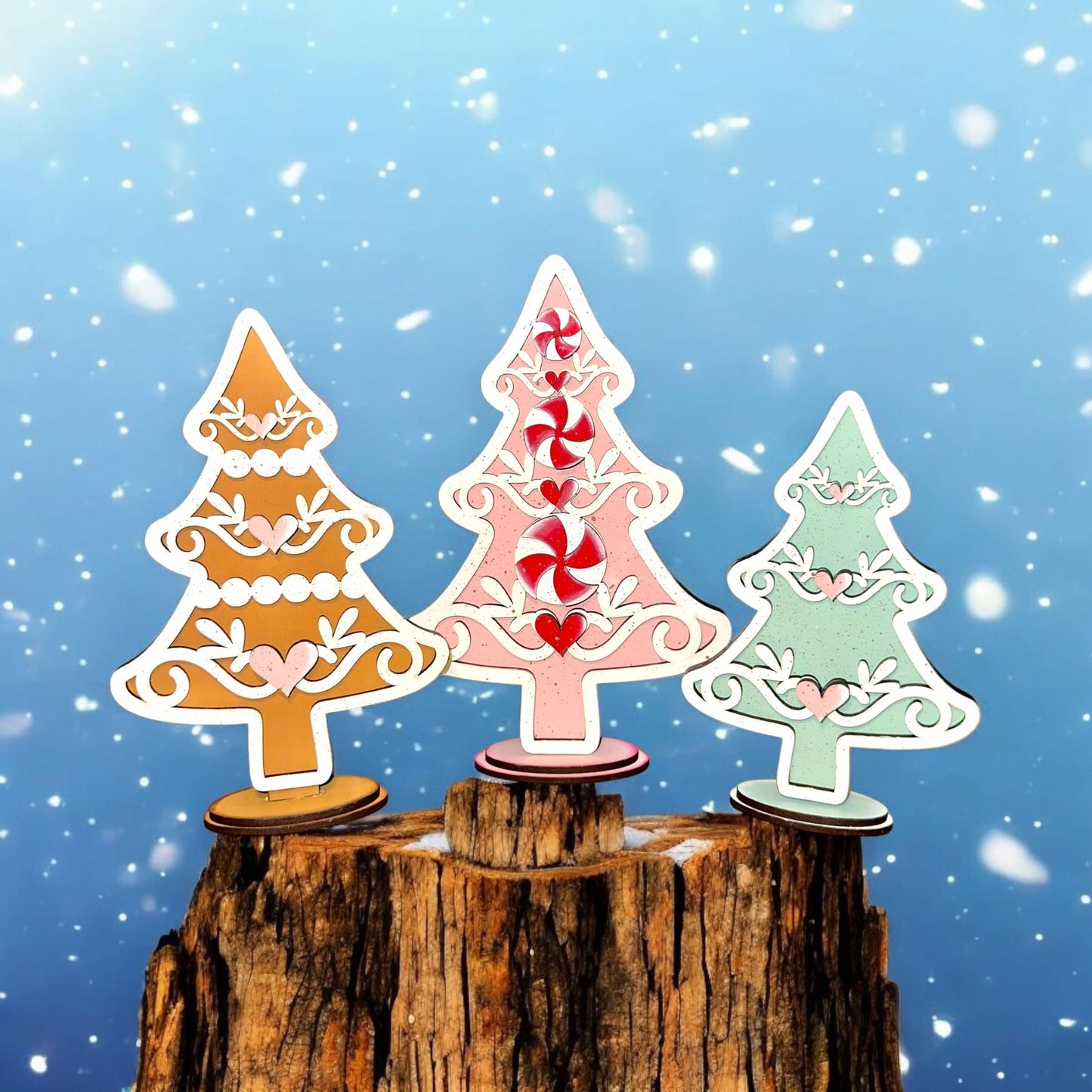 three paper cut christmas trees on top of a tree stump