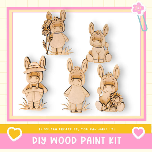 a DIY wood paint kit with five wooden animal figurines, including a donkey, a rabbit, and a bird, each holding a flower. The kit appears to be designed for children to create their own wooden animal characters.