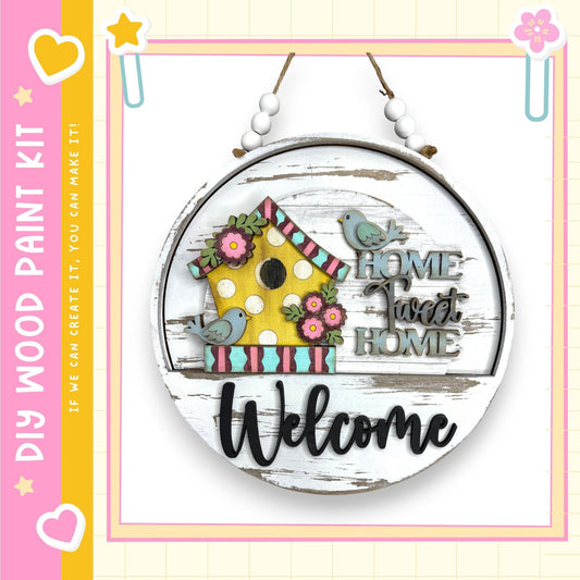 A wooden sign with a birdhouse and the text "Welcome Home" hanging on a wall.