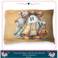 A pillow with a Halloween-themed design featuring a ghost, pumpkin, and bow.