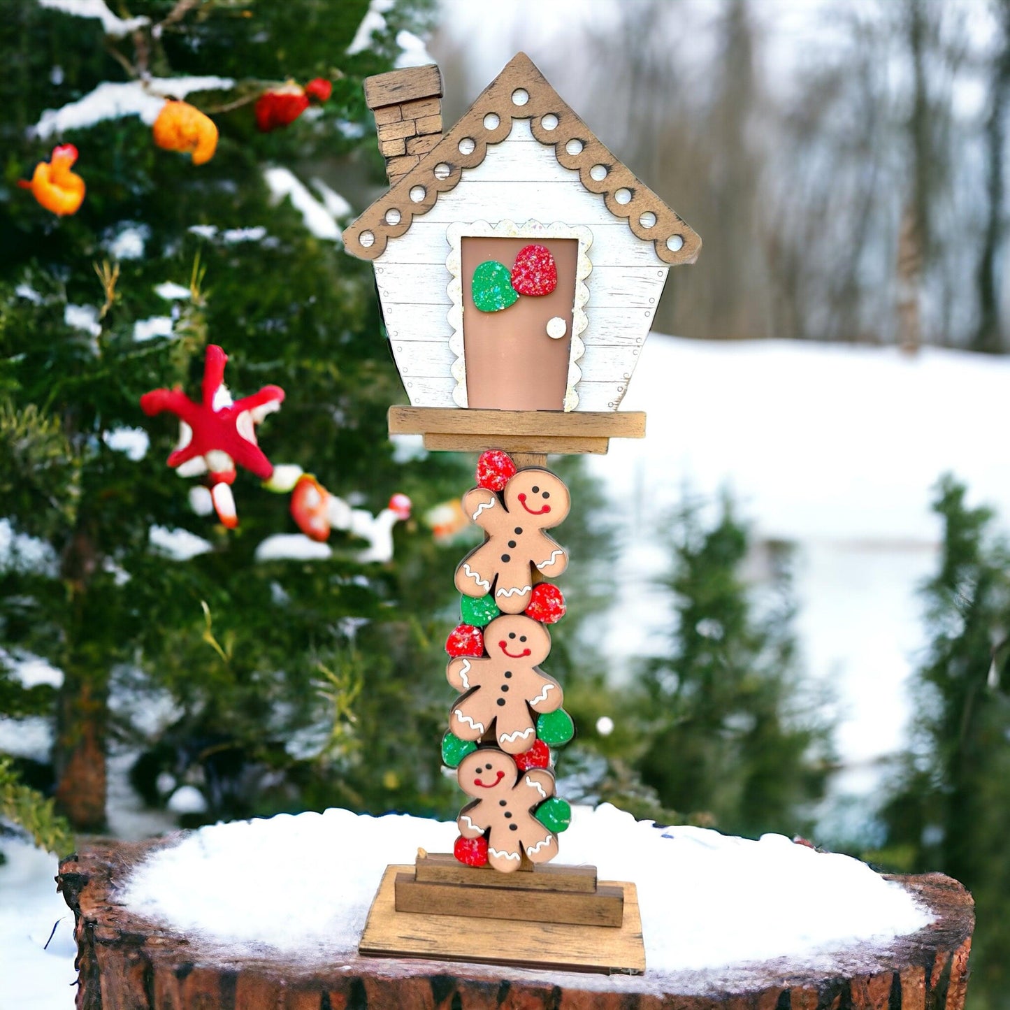 a christmas tree with a birdhouse on top of it