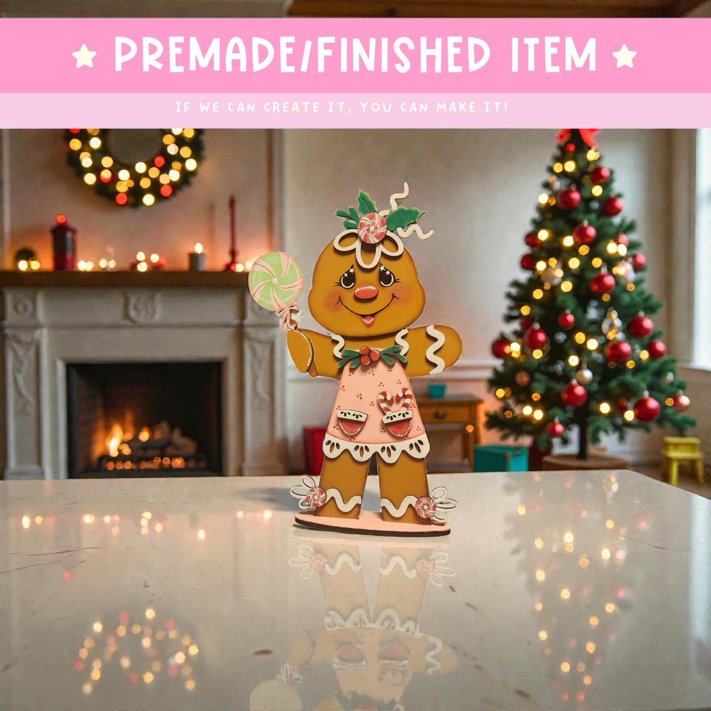 A gingerbread man figurine is sitting on a white marble countertop, with a Christmas tree and wreath in the background.