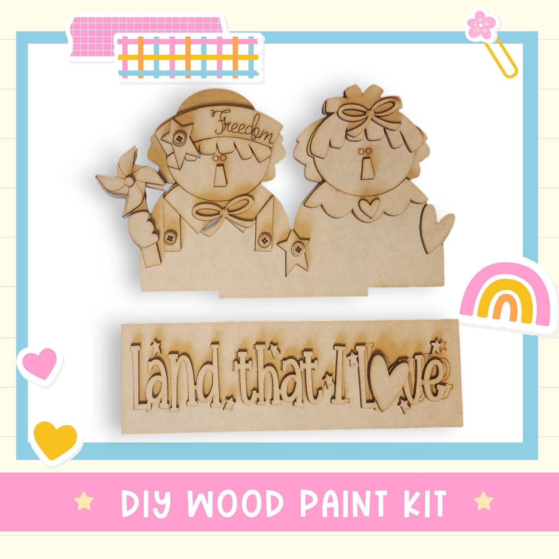 The image is a DIY wood paint kit featuring two wooden figures and a sign with the phrase "Land that I love".