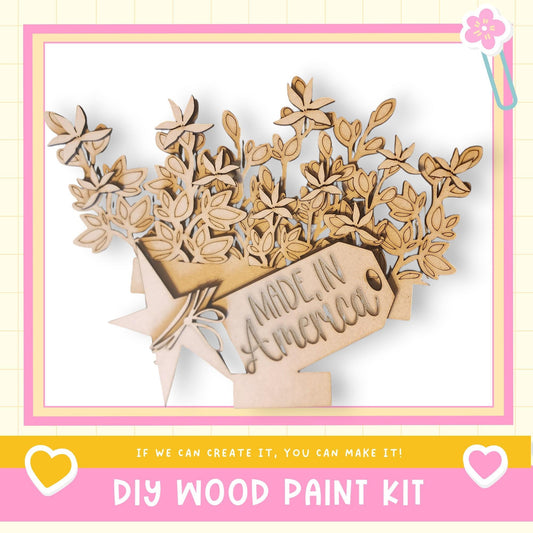 The image is a DIY wood paint kit advertisement, featuring a wooden tree with leaves and flowers, along with the text "Made in America" and a heart symbol.