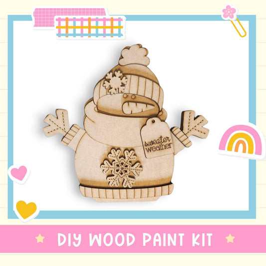 a DIY wood paint kit for creating a wooden snowman, with a colorful background and various decorative elements.