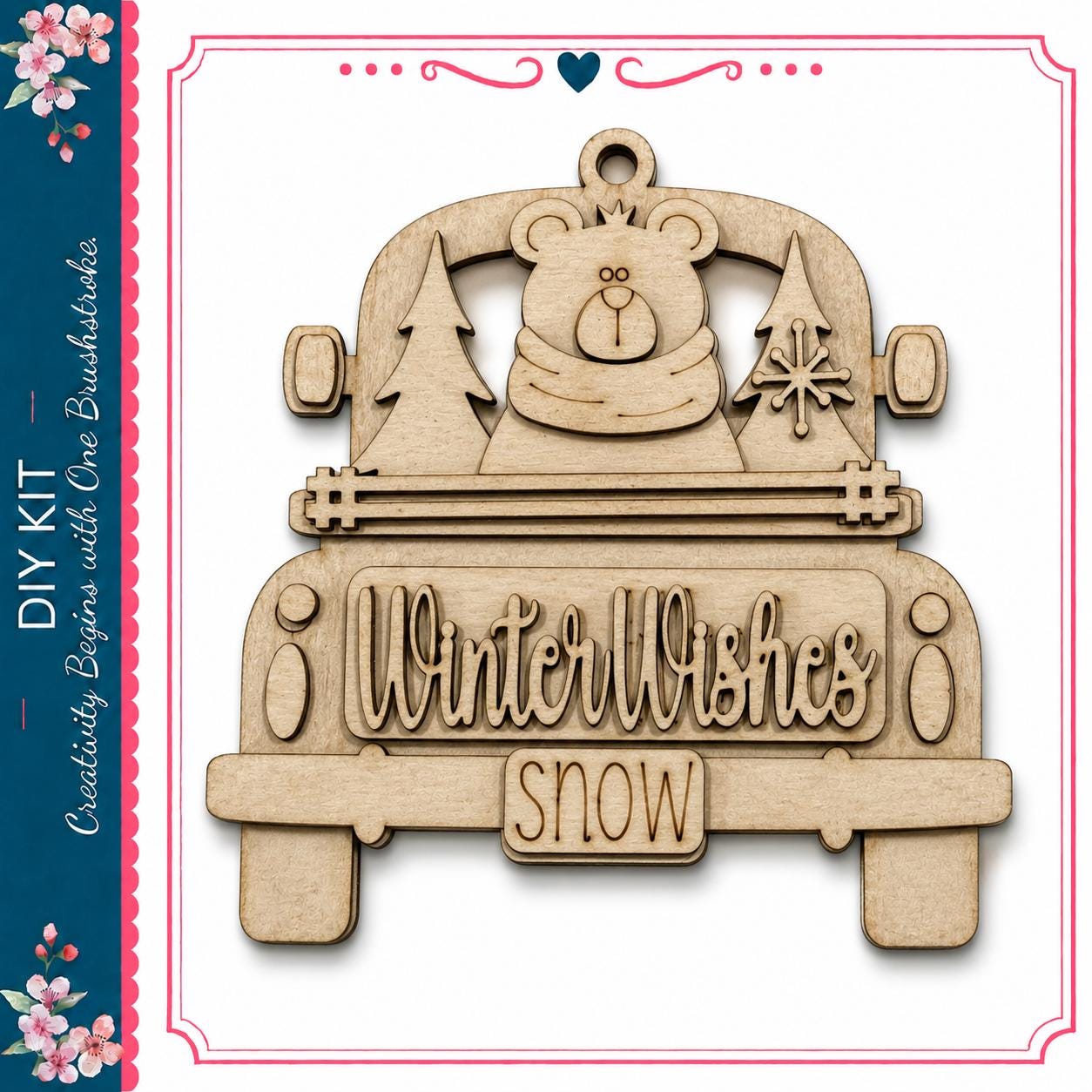 A wooden ornament in the shape of a truck with a bear and snowflakes on the back.