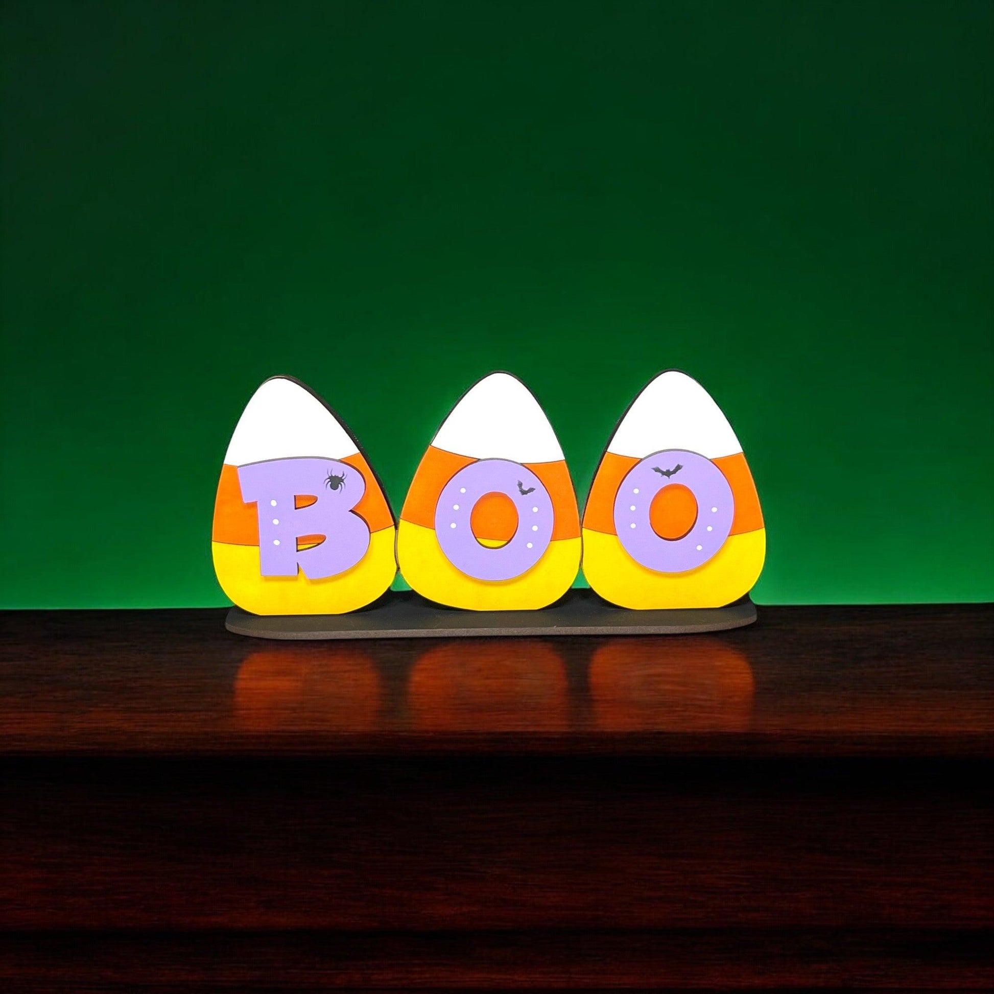 three decorated eggs sitting on top of a wooden table