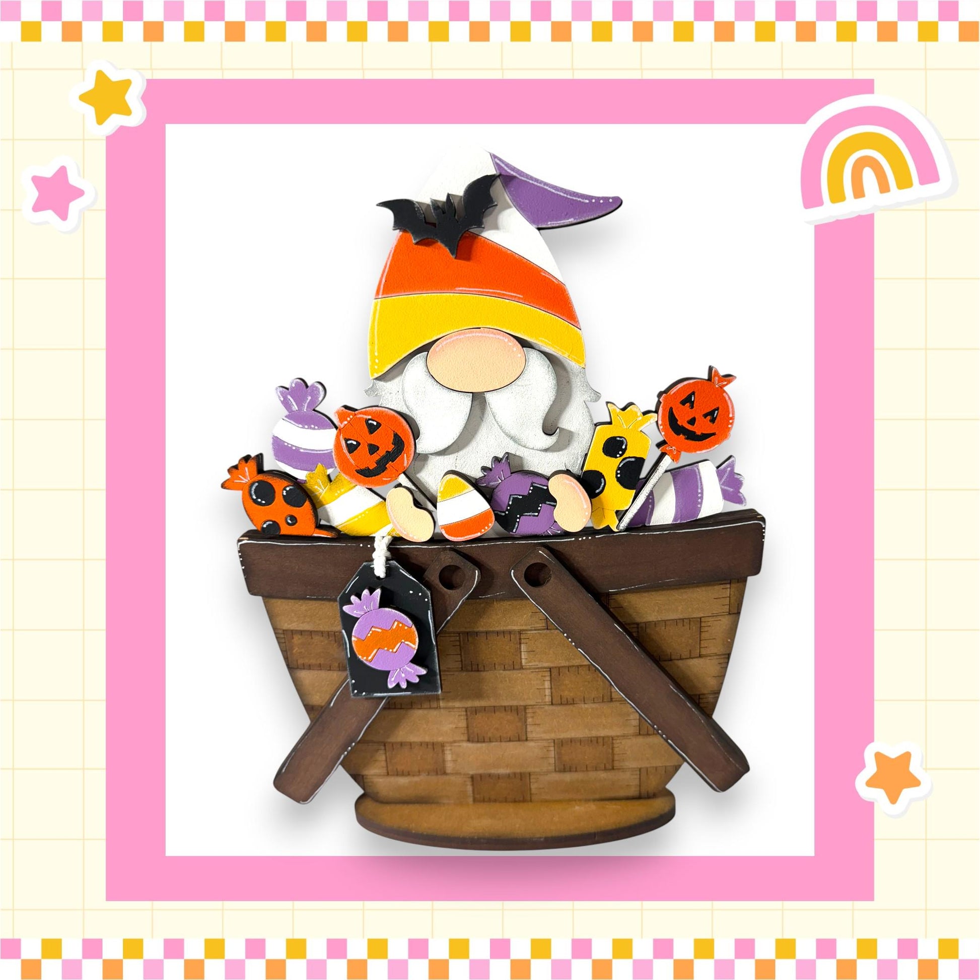 A wooden basket filled with Halloween-themed candies, including a gnome figure, a bat, and a rainbow, set against a pink and yellow background with stars and a rainbow.