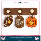 a rustic farmhouse DIY kit with a football, pumpkin, and leaf-shaped sign, all hanging on a wooden board.