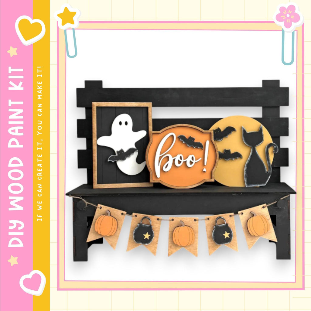 a Halloween-themed display with a black bench, a ghost, a cat, and a pumpkin. The bench has a sign that says "boo!" and a banner with pumpkins and bats hanging from it.