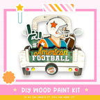 The image is a colorful and playful DIY wood paint kit featuring a wooden truck with a football player and various football-related items.
