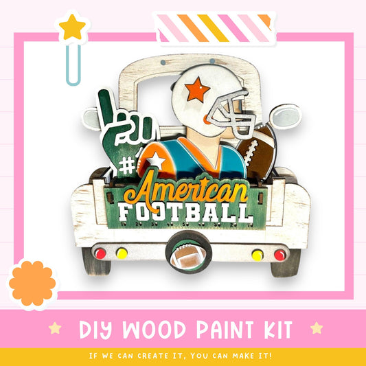 The image is a colorful and playful DIY wood paint kit featuring a wooden truck with a football player and various football-related items.
