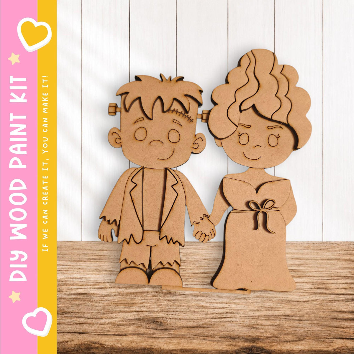 two wooden cutouts of a boy and a girl, standing together and smiling.