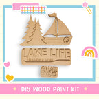 a wooden cutout of a boat with a rainbow in the background