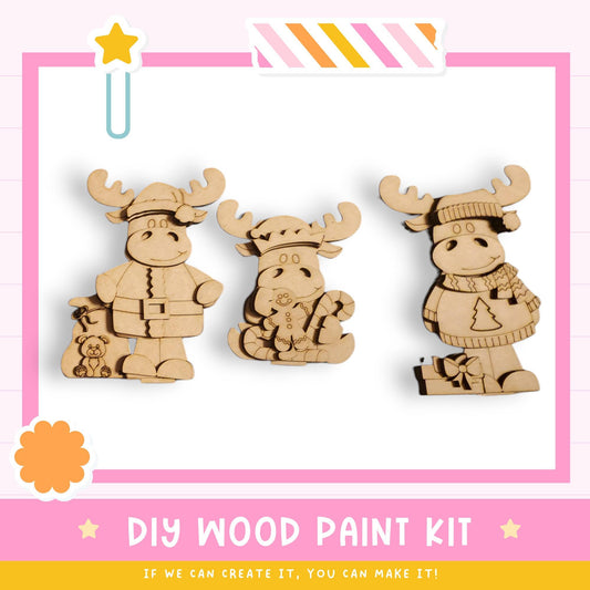 three wooden toy animals, likely moose or reindeer, posed in a playful manner. The text below the image suggests that it is a DIY wood paint kit, and if the viewer can create it, they can make it.