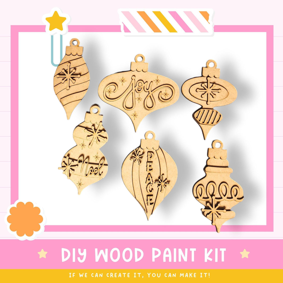 a DIY wood paint kit with six wooden ornaments in various shapes and designs, including stars, snowflakes, and the word "Joy". The kit appears to be made of wood and is displayed against a pink and white background.