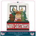 A festive Christmas-themed decoration featuring a moose wearing a scarf and surrounded by snowflakes, pine trees, and a "Merry Christmas" sign.