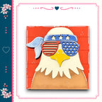 A wooden eagle wearing sunglasses with an American flag design, set against a red background.