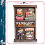 The image is a wooden display with various fall decorations, including pumpkins, a scarecrow, and a sign that says "V-PICK". The display appears to be a creative DIY project, possibly for a pumpkin patch or fall-themed room.
