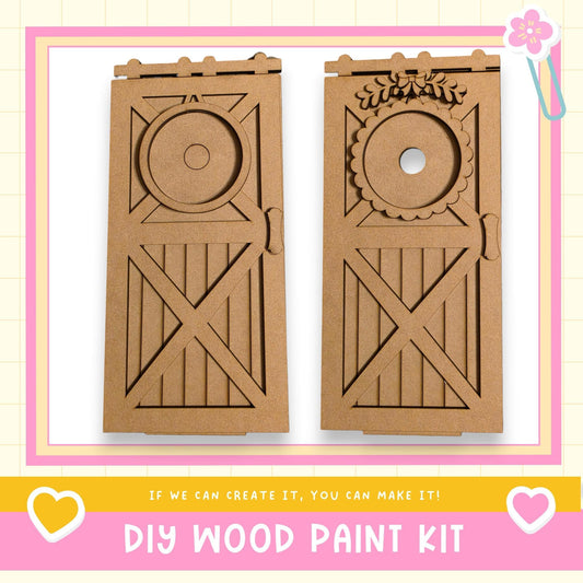 two wooden doors made of cardboard, with decorative elements such as a circular cutout and a floral design. The text below the image reads "DIY WOOD PAINT KIT" and "If we can create it, you can make it!"